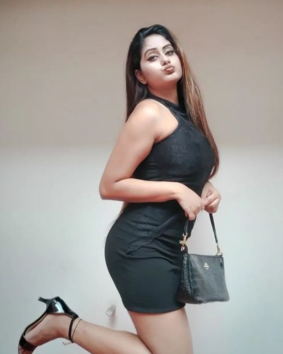 A WHITE FACE AND BODY CUTE GILR IN BLACK DRESS AND BLACK BAG TAKING POSE LOOKS